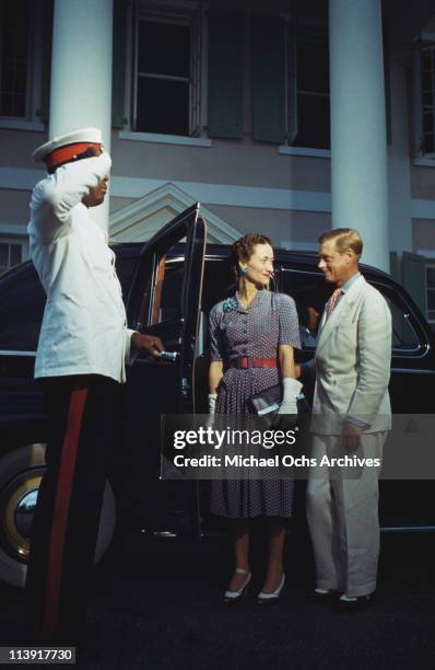 Chauffeur salutes as Wallis, Duchess of Windsor and the Duke of Windsor get into a car outside Goverment House in Nassau, the Bahamas, circa 1942....