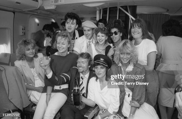English businessman Richard Branson celebrates the first flight of his Virgin Atlantic airline with a group of celebrities, London, 23rd June 1984....