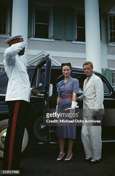 Chauffeur salutes as Wallis, Duchess of Windsor and the Duke of Windsor get into a car outside Goverment House in Nassau, the Bahamas, circa 1942....