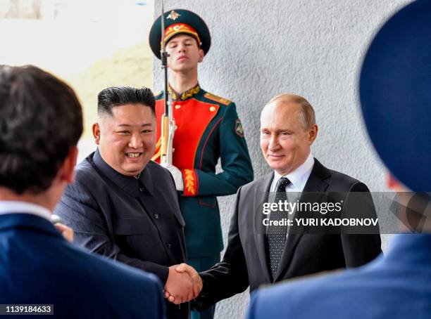 Russian President Vladimir Putin welcomes North Korean leader Kim Jong Un prior to their talks at the Far Eastern Federal University campus on Russky...