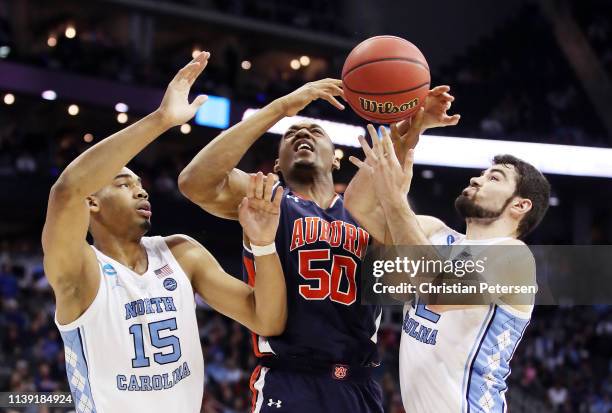 Austin Wiley of the Auburn Tigers battles for the ball with Garrison Brooks and Luke Maye of the North Carolina Tar Heels during the 2019 NCAA...