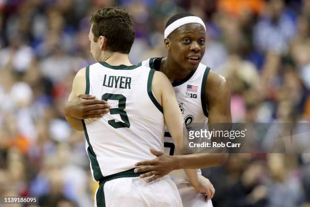 Foster Loyer and Cassius Winston of the Michigan State Spartans celebrate after defeating the LSU Tigers in the East Regional game of the 2019 NCAA...