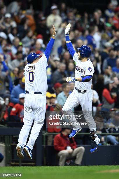 Ryan Braun of the Milwaukee Brewers celebrates a three-run home run with third base coach Ed Sedar during the third inning of a game against the St....