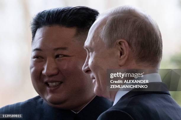 Russian President Vladimir Putin welcomes North Korean leader Kim Jong Un prior to their talks at the Far Eastern Federal University campus on Russky...