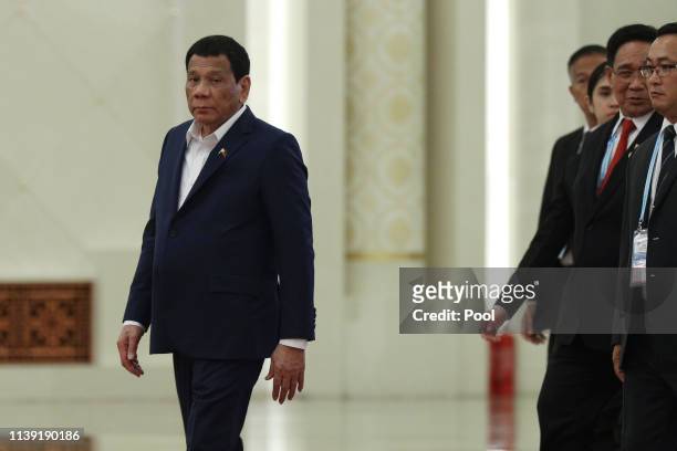 Philippine President Rodrigo Duterte, left, arrives for the meeting with Chinese President Xi Jinping, unseen, at the Great Hall of People in...