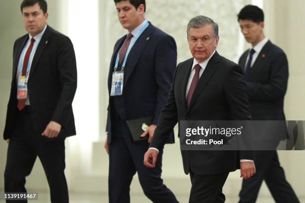 Uzbek president Shavkat Mirziyoyev, 2nd right, arrives for the meeting with Chinese President Xi Jinping, unseen, at the Great Hall of People on...