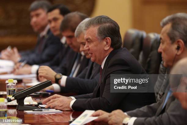 Uzbek president Shavkat Mirziyoyev, center, talks with Chinese President Xi Jinping, unseen, during the meeting at the Great Hall of People on April...