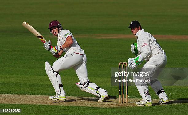 Somerset batsman Nick Compton hits out to the leg side watched by Phil Mustard during day one of the LV County Championship Division One match...