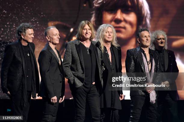 Inductees Rick Allen, Phil Collen, Joe Elliott, Rick Savage and Vivian Campbell of Def Leppard and Queen’s Brian May speak onstage during the 2019...