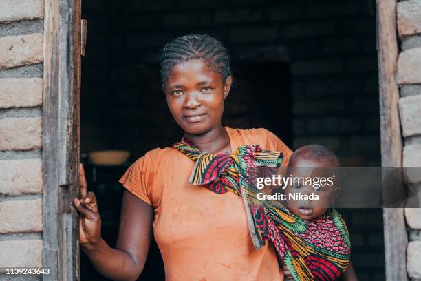 african mother with baby son at home - malawi stock pictures, royalty-free photos & images