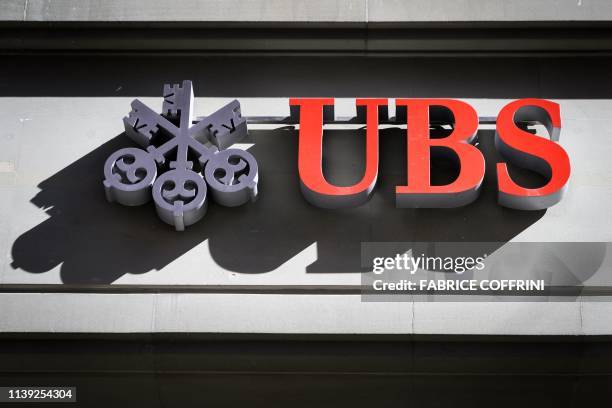 Sign of Swiss banking giant UBS is seen on a branch in Bern on April 25, 2019 in Bern. - UBS said today that revenue and profits both slid in the...