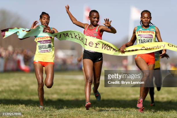 Beatrice Chebet of Kenya crosses the line to win the Women's U20 Final as Alemitu Tariku of Ethiopia reacts to coming second during the IAAF World...