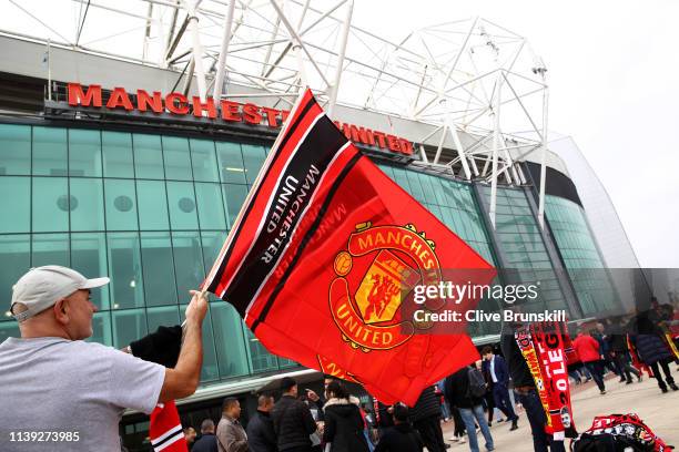 Manchester United flags are seen for sale outside the stadium prior to the Premier League match between Manchester United and Watford FC at Old...