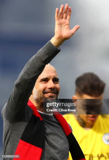 Josep Guardiola, Manager of Manchester City celebrates whilst wearing a black and red scarf in memory of former club secretary Bernard Halford...