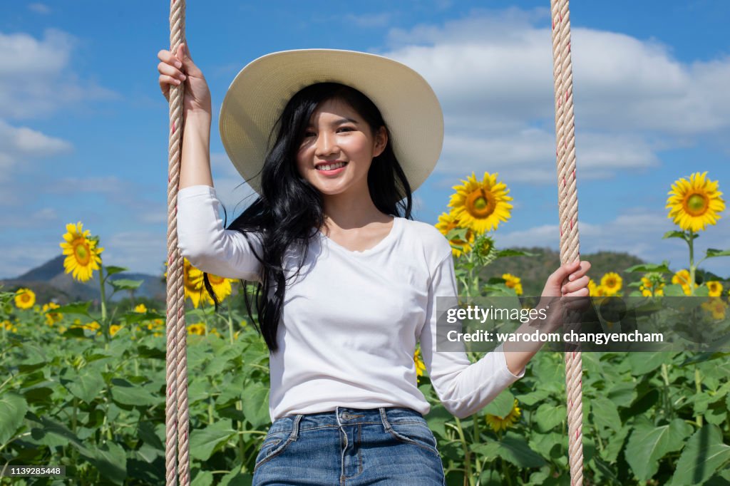 Asian young woman visit sunflower field - Image