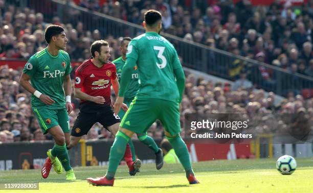 Juan Mata of Manchester United in action with Miguel Britos of Watford during the Premier League match between Manchester United and Watford FC at...