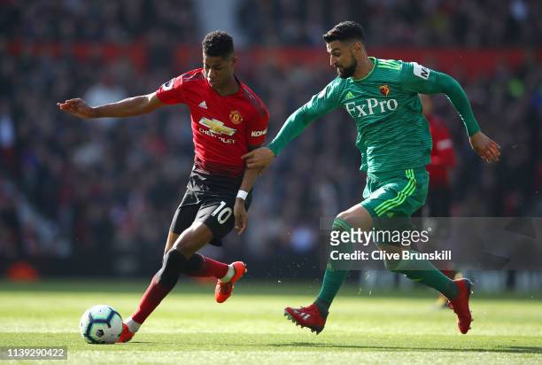 Marcus Rashford of Manchester United battles for possession with Miguel Britos of Watford during the Premier League match between Manchester United...