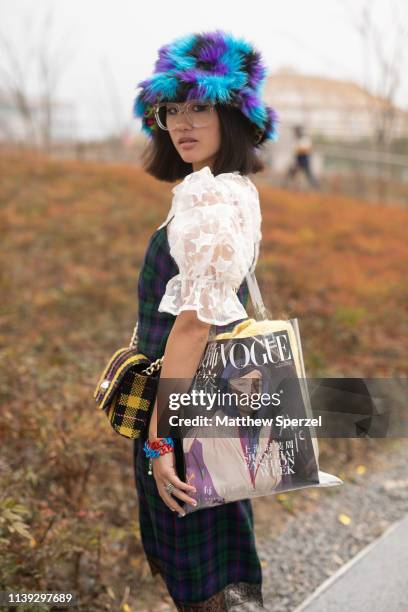 Guest is seen on the street attending Labelhood during Shanghai Fashion Week A/W 2019/2020 wearing blue/purple faux fur top-hat, white lace star...