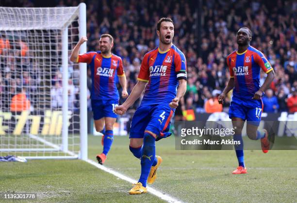 Luka Milivojevic of Crystal Palace celebrates with teammates after scoring his team's first goal during the Premier League match between Crystal...
