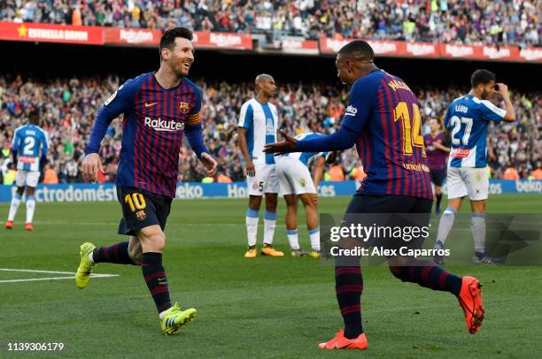 Lionel Messi of Barcelona celebrates with teammate Malcom after scoring his team's second goal during the La Liga match between FC Barcelona and RCD...