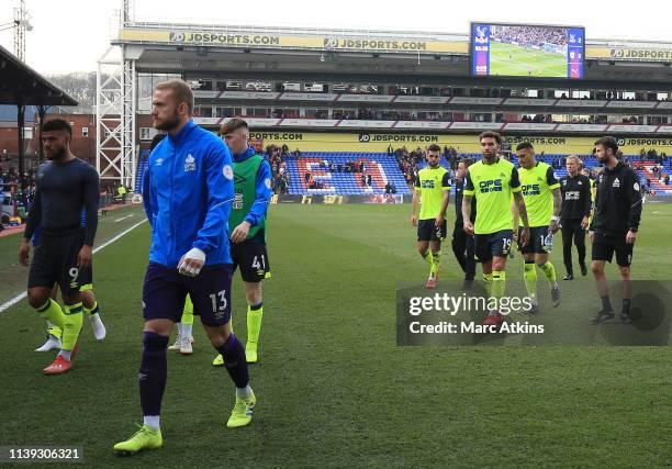 Huddersfield Town players look dejected as they leave the pitch following a loss which results in their relegation following the Premier League match...