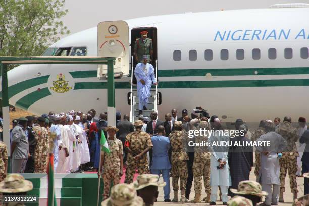 Nigeria President Muhammadu Buhari arrives at the Air Force base in Maiduguri on April 25, 2019. - Buhari will leave for Britain on April 25 on a...