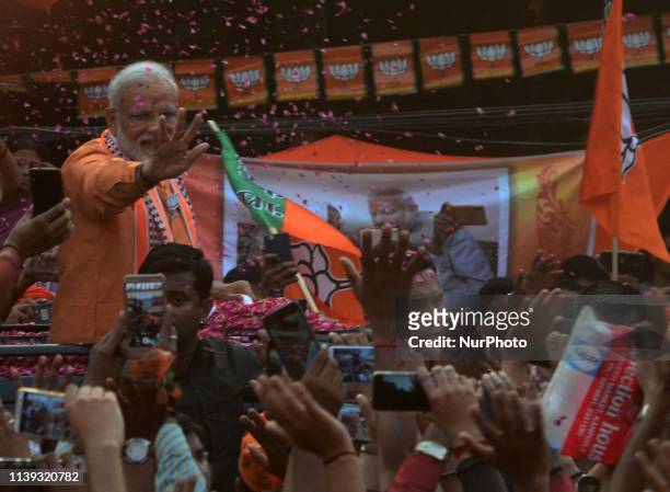 Indian Prime Minister Narendra Modi waves towards supporters during his road show in Varanasi on April 25, 2019 . PM Modi is visiting his...