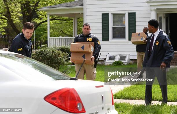 Federal agents remove items from the home of Baltimore Mayor Catherine Pugh in the 3400 block of Ellamont Rd as they execute a search warrant, on...