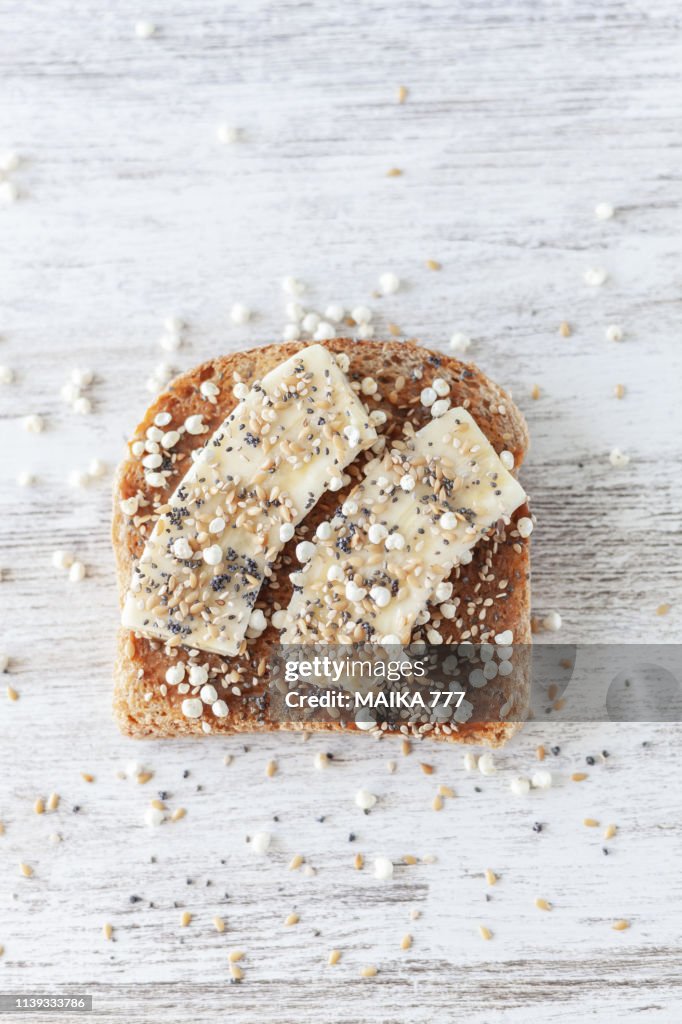 Gluten free whole grain bread with almond butter, banana, puffed millet with honey, golden flax, chia, sesame and poppy seeds