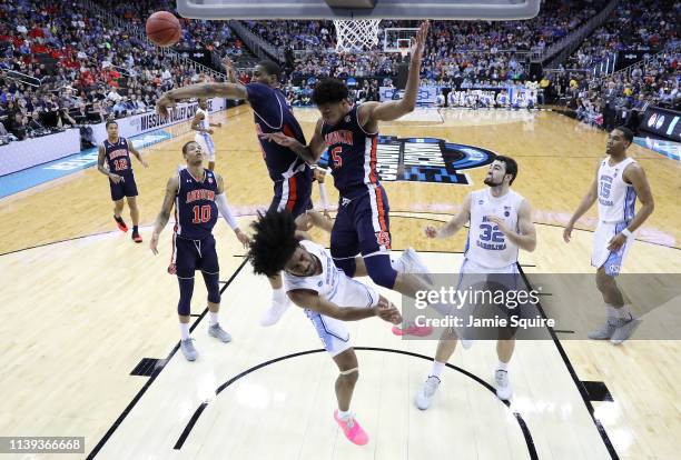 Horace Spencer and Chuma Okeke of the Auburn Tigers block a shot by Coby White of the North Carolina Tar Heels during the 2019 NCAA Basketball...