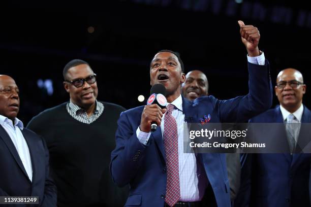 Former Detroit Piston Isiah Thomas talks to the crowd during a celebration of the 1989 and 1990 World Championship Detroit Pistons at halftime during...