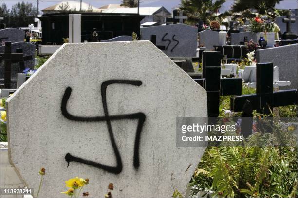 Desecration of a cemetery in St. Pierre de la Reunion, In France On November 17, 2004-Swastikas and the initials "SS" were tagged on 14 tombs and the...