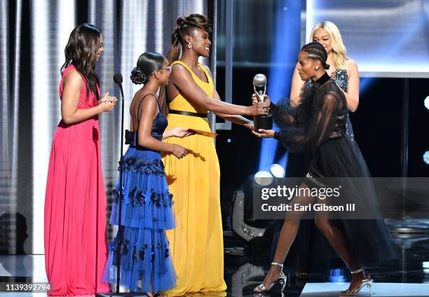 Regina Hall, Marsai Martin, and Issa Rae present the Outstanding Breakthrough Role in a Motion Picture award to Letitia Wright onstage at the 50th...