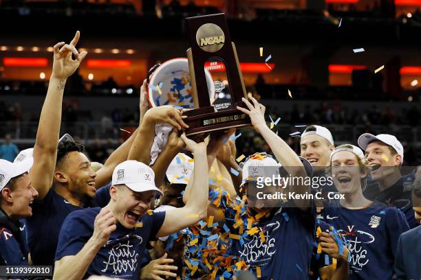 The Virginia Cavaliers raise the trophy after defeating the Purdue Boilermakers 80-75 in overtime of the 2019 NCAA Men's Basketball Tournament South...