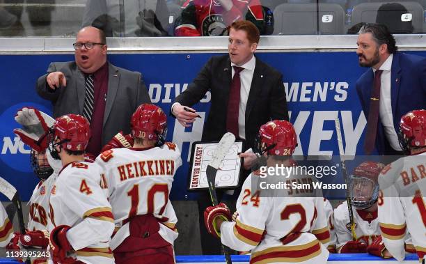 Assistant coach Dallas Ferguson and head coach David Carle of the Denver Pioneers give instructions their team during the NCAA Division I Men's Ice...