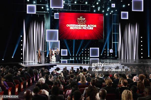 Chadwick Boseman accepts the Outstanding Actor in a Motion Picture award for 'Black Panther' from Kate Beckinsale and Danai Gurira onstage at the...