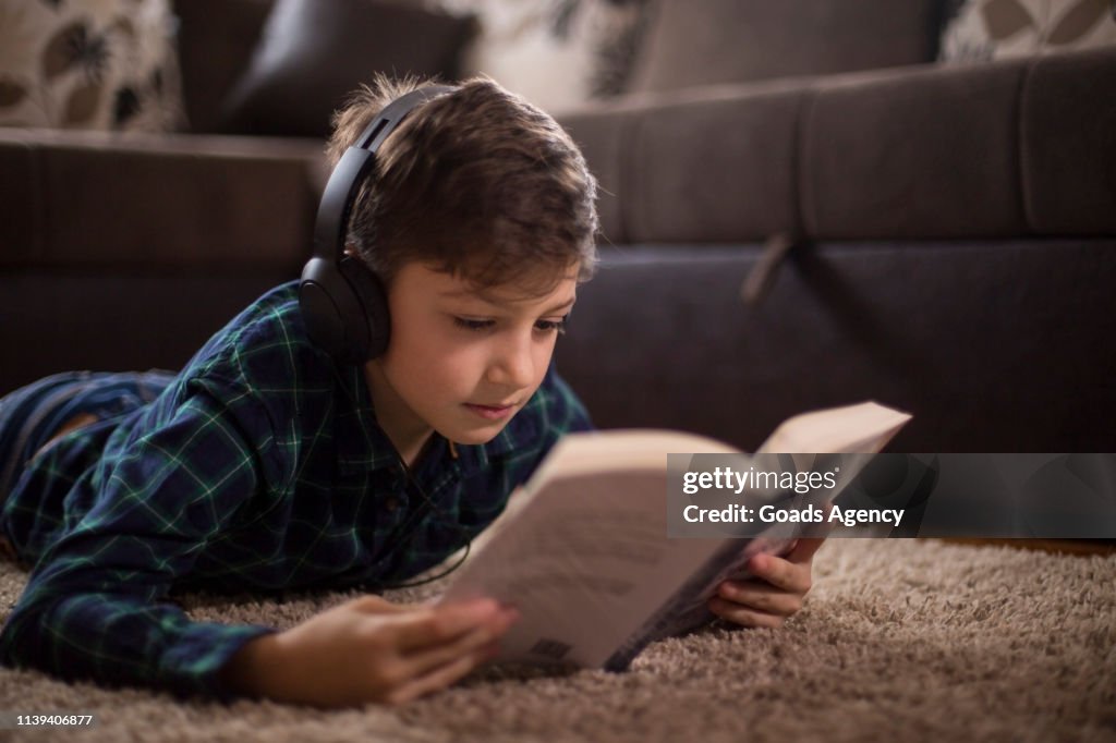 Enjoying the music and reading a book
