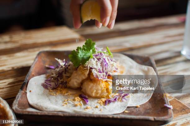 salted egg shrimp in flour tortilla with freshly squeezed lime - making a sandwich stock pictures, royalty-free photos & images