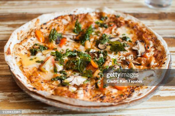 pesto and mushroom pizzadilla - flatbread pizza stock pictures, royalty-free photos & images