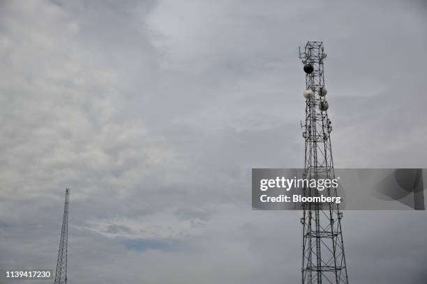 Antennas hang from a Scientel Solutions LLC transmission tower, right, near the CyrusOne, Inc. Tower, left, in Aurora, Illinois, U.S., on Wednesday,...