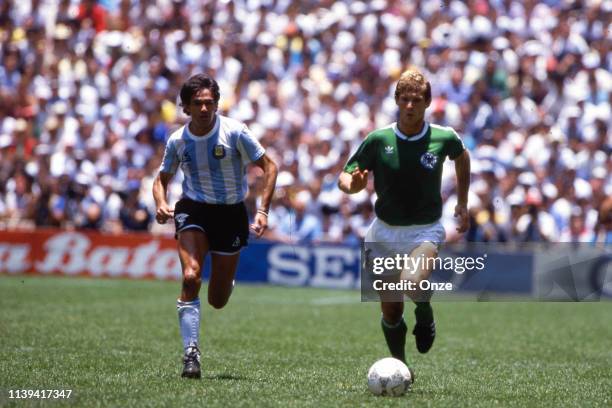 Jorge Burruchaga of Argentina and Karlheinz Forster of West Germany during the World Cup Final match between Argentina and West Germany at Estadio...