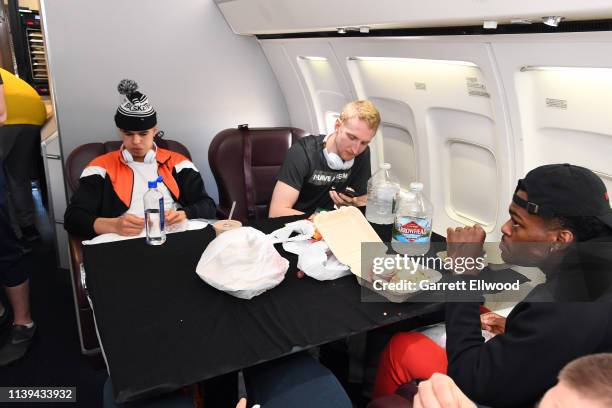 Michael Porter Jr. #1 and Thomas Welsh of the Denver Nuggets eat on a plane to San Antonio on April 24, 2019 at Denver International Airport in...