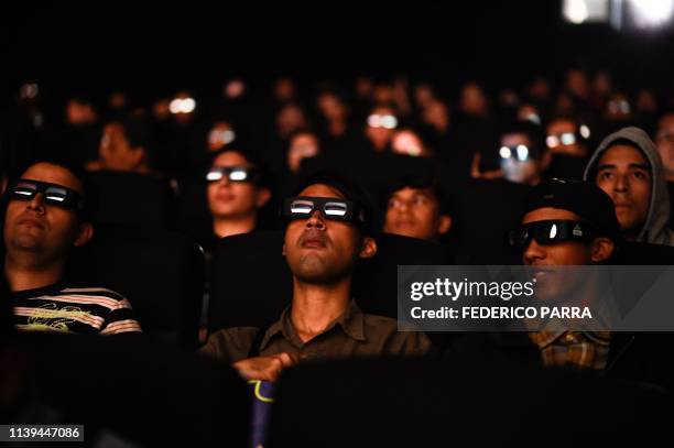 Venezuelan filmgoers watch the first screening in Venezuela of Marvel Studios' "Avengers: Endgame" at a cinema in Caracas on early April 26, 2019. -...