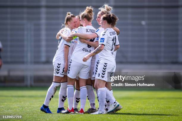 Janina Minge of Freiburg celebrates her team's first goal with her team mates during the Women's DFB Cup Semi Final between TSG Hoffenheim and SC...