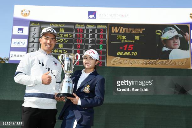 Yui Kawamoto of Japan and her caddie pose for photos after winning during the AXA Ladies Golf Tournament at the UMK Country Club on March 31, 2019 in...