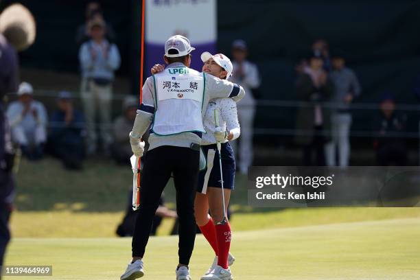 Yui Kawamoto of Japan celebrates with her caddie after winning the AXA Ladies Golf Tournament at the UMK Country Club on March 31, 2019 in Miyazaki,...