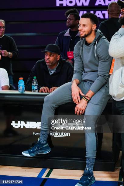 Dell Curry and Stephen Curry watch the players at the Underrated Tour on March 30, 2019 in Oakland, California.