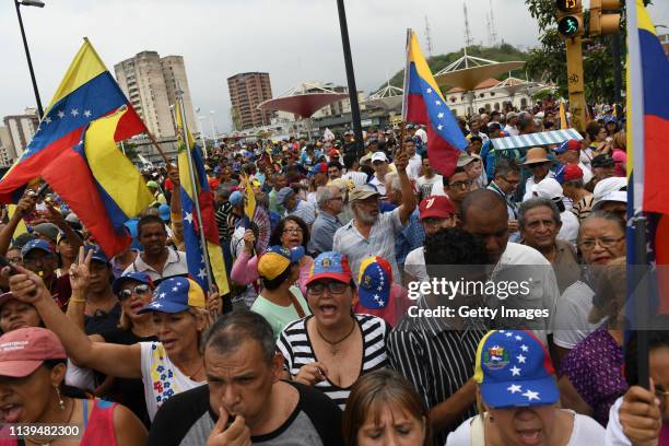 Demonstrators shout slogans during a rally of Venezuelan opposition leader Juan Guaidó, recognized by many members of the international community as...