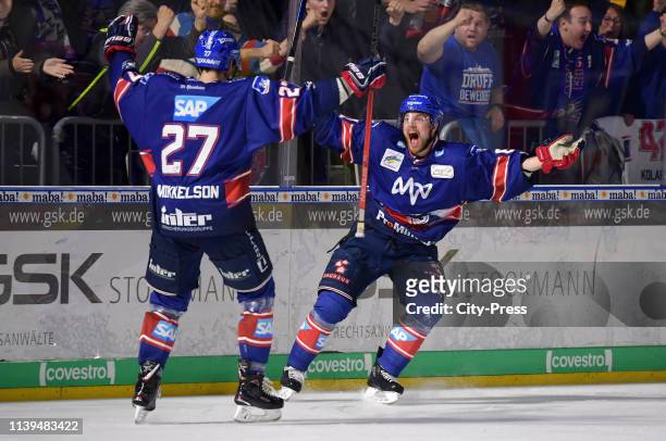 Brendan Mikkelson and Tommi Huhtala of the Adler Mannheim celebrate after scoring the 4:1 during the game between the Adler Mannheim and the EHC Red...