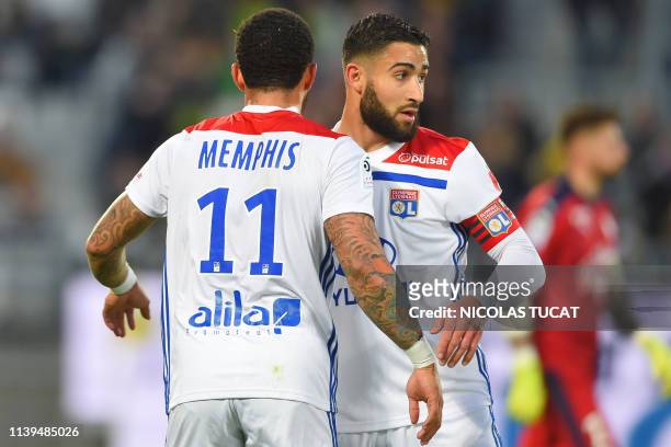 Lyon's Dutch forward Memphis Depay celebrates with Lyon's French midfielder Nabil Fekir after scoring a goal during the French L1 football match...